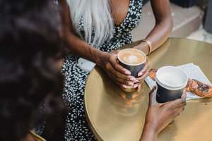 black women holding coffee