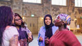 Group of black women stood talking