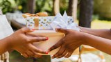 black woman passing gifts